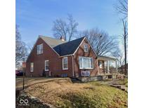 Charming brick home with a cozy front porch and well-maintained lawn and an interesting roofline at 604 Walnut St, Anderson, IN 46012