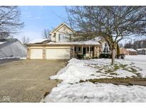 Two-story house with attached two-car garage and snow-covered front yard at 6116 Prairie Stream Way, Columbus, IN 47203