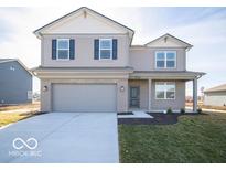 Charming two-story home with gray siding, brick accents, a two-car garage, and a well-manicured front lawn at 6349 Granby Dr, Whitestown, IN 46075
