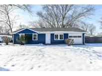 Newly renovated blue house with snow covered front yard at 1305 Woodbine Dr, Anderson, IN 46011