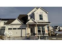 Two story house with white siding, two car garage, and covered front porch at 13359 Vickery Ridge Dr, Fishers, IN 46037