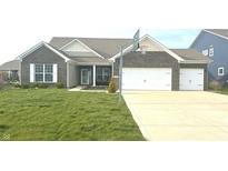 Charming single-story home features a well-manicured lawn and a two-car garage with a basketball hoop at 15142 Blue Ribbon Blvd, Fishers, IN 46040
