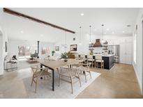 Bright, open concept living space featuring a modern kitchen, dining area, and inviting living room with high ceilings at 1600 S Morgantown Rd, Morgantown, IN 46160