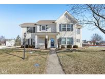 Two-story house with a light beige exterior, landscaping, and walkway at 1655 Arbor Springs Dr, Brownsburg, IN 46112