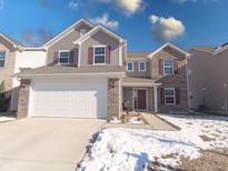 Two-story house with gray siding, brick accents, and a white garage door at 1715 Danielle Rd, Lebanon, IN 46052