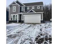 Charming two-story home featuring gray siding, white trim, and an attached two-car garage at 250 Ambassador Dr, Pittsboro, IN 46167