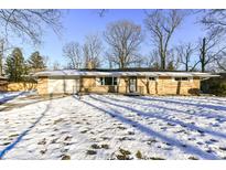 Ranch home with snow covered lawn at 3375 Lincoln Rd, Indianapolis, IN 46222