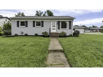 Ranch style home with gray exterior, landscaped lawn, and walkway at 5201 N White Ln, Lawrence, IN 46226