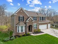Attractive two-story brick home with an attached two-car garage and landscaped front yard at 6711 Colville Pl, Indianapolis, IN 46236