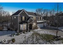 Two-story brick home with a spacious front yard and attached garage at 6711 Colville Pl, Indianapolis, IN 46236