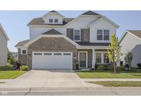 Charming two-story home featuring a stone facade, attached two-car garage, and manicured front yard at 1001 Parker Ln, Westfield, IN 46074