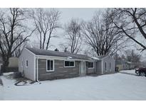Gray vinyl-sided ranch home with stone accents, snowy front yard at 117 Tracy Rd, Whiteland, IN 46184