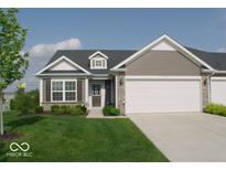 Charming single-story home with a well-manicured lawn, attached garage, and classic architectural details at 173 Megan Way, Cumberland, IN 46229