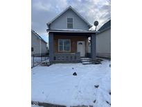 Charming gray house with wood siding and snowy front yard at 2357 Southeastern Ave, Indianapolis, IN 46201