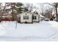 Quaint ranch home with snow covered yard at 2515 Fairfax Rd, Indianapolis, IN 46227