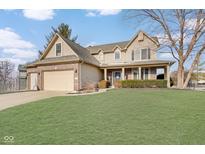 Two-story house with a brick facade, attached garage, and well-manicured lawn at 5230 Berkshire South Blvd, Greenwood, IN 46142