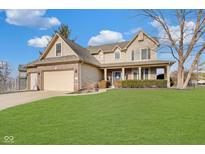 Charming two-story home featuring a brick-accented facade, attached garage, and a well-manicured lawn under a bright, cloudy sky at 5230 Berkshire South Blvd, Greenwood, IN 46142