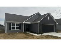 Charming single-story home featuring gray siding, a black brick garage, and a well-manicured lawn at 943 Aurora Ln, Franklin, IN 46131
