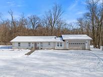 Ranch-style home with attached garage, nestled in a wooded area at 9791 N Gasburg Rd, Mooresville, IN 46158