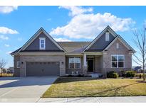 Charming single-Gathering home boasts a well-manicured lawn, attached garage, and a welcoming front porch at 19226 English Lake Ln, Noblesville, IN 46062