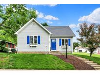 Charming single-story home with blue accents and landscaped front yard, perfect curb appeal at 207 E Ohio St, Fortville, IN 46040