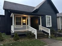 Charming dark-colored house with a white porch and well-maintained lawn at 227 Van Ave, Shelbyville, IN 46176