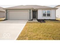 A charming single-story home featuring a two-car garage and well-manicured lawn at 3231 W Keepsake Ln, Monrovia, IN 46157