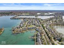 Community aerial view showcasing waterfront homes, scenic landscaping, and sparkling blue water at 3543 Clearwater Cir, Indianapolis, IN 46240