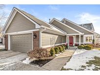 Gray siding two-story home with red door, attached garage, and landscaping at 3543 Clearwater Cir, Indianapolis, IN 46240
