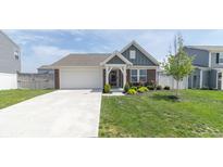 Brick ranch home with attached garage and landscaped front yard at 653 Springdale Ln, Greenfield, IN 46140