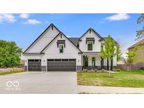 Striking two-story home featuring a three-car garage and a modern farmhouse design at 6752 W Buck Stone Dr, McCordsville, IN 46055