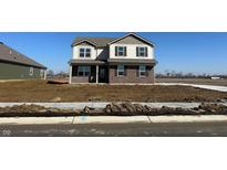 New two-story home showcasing neutral siding, brick accents, and a well-lit facade at 7824 Magnolia St, New Palestine, IN 46163