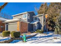 Gray and brick two-story home with attached garage, snow-covered landscaping, and a fire hydrant at 8022 Talliho Dr, Indianapolis, IN 46256