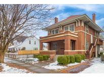 Brick two-story home with snowy front yard at 1023 Franklin St, Columbus, IN 47201