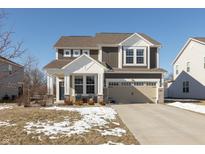 Two-story house with brown siding, white accents, and a two-car garage at 1094 Sunset Blvd, Avon, IN 46123