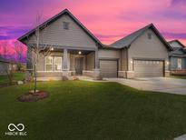 Two-story home with gray siding, stone accents, and a two-car garage at 12507 Pasco St, Fishers, IN 46038