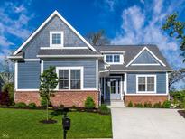 Charming two-story home featuring blue siding, brick accents, and a well-manicured front yard at 20188 Hampton Park Dr, Westfield, IN 46074