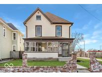 Two-story house with a front porch and brick accents at 2450 Carrollton Ave, Indianapolis, IN 46205