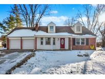 Brick ranch home with attached two-car garage and snow-covered yard at 2934 S Irwin St, Indianapolis, IN 46203