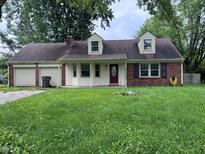Charming single-Gathering home with brick accents, dormer windows and an attached two-car garage at 2934 S Irwin St, Indianapolis, IN 46203