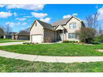 Charming two-story brick home with well-manicured lawn and two-car garage at 386 White Oak Ln, Greenwood, IN 46142