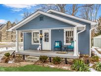 Charming blue house with a welcoming porch and well-manicured lawn at 4926 Crittenden Ave, Indianapolis, IN 46205