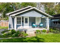 Quaint home with welcoming front porch and cozy seating area at 4926 Crittenden Ave, Indianapolis, IN 46205