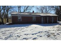 Brick ranch house with snow-covered yard at 7903 Roseway Ct, Indianapolis, IN 46226