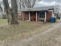 Charming brick home with covered porch and gravel driveway at 7903 Roseway Ct, Indianapolis, IN 46226