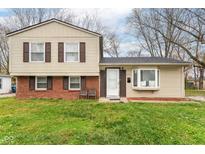 Brick and beige two-story house with a well-maintained lawn at 8224 Barry Rd, Indianapolis, IN 46219