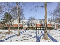 Brick ranch house with snow covered lawn and mature trees at 2054 Horizon Blvd, Greenwood, IN 46143