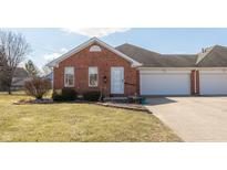 Charming red brick townhome features a well-manicured lawn and an attached one-car garage at 306 Vinewood N Dr, Brownsburg, IN 46112
