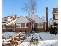 Brick ranch house with a snow-covered front yard at 31 N Kenmore Rd, Indianapolis, IN 46219