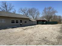 Beige building with gravel parking lot and partially fenced side yard at 3480 S Us Highway 31, Franklin, IN 46131